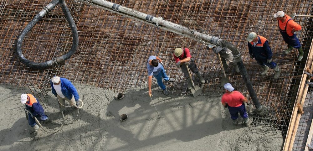 Men spreading concrete | Allbrite Construction