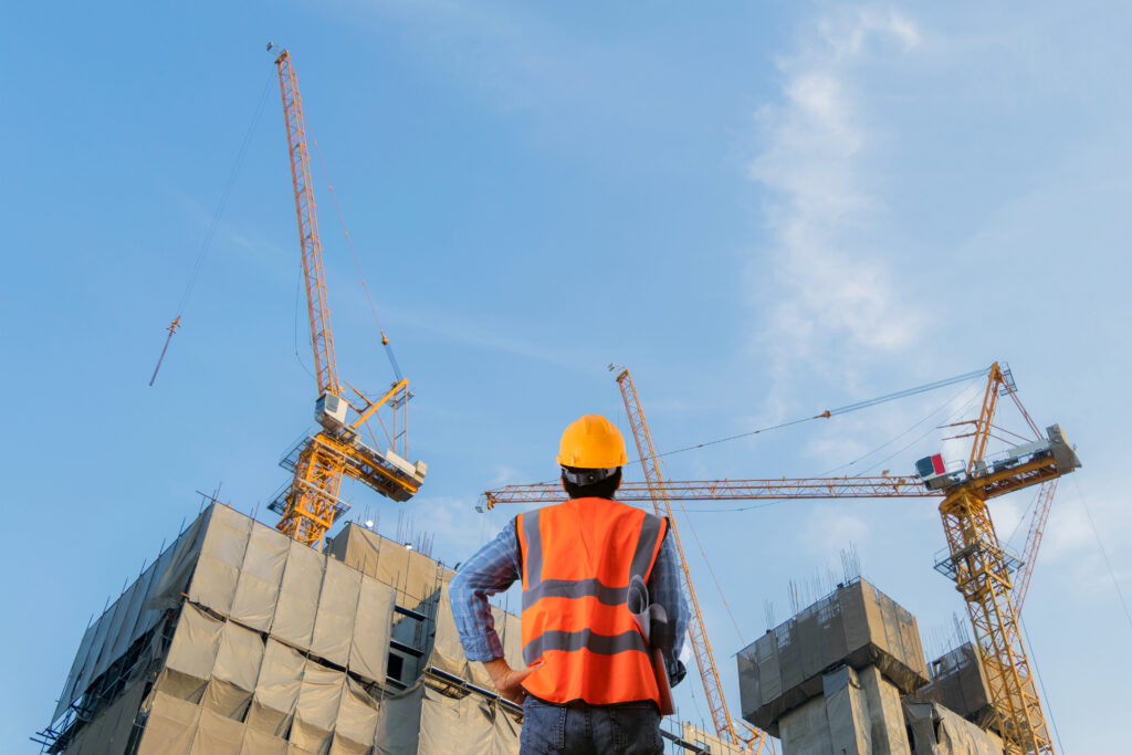 construction worker standing in front of a construction site Allbrite Construction commercial contractors San Antonio