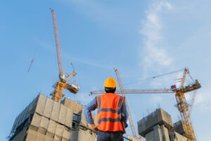 construction worker standing in front of a construction site Allbrite Construction commercial contractors San Antonio